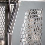 Close-up of the dog box ventilation panel and gas strut support inside the aluminium canopy