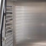 Interior of UTE dog box with clean alloy walls and ventilation panels