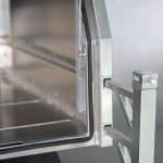 Close-up of UTE canopy’s door hinge and support arm assembly