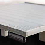 Close-up of an aluminum single cab tray with a flat surface, durable construction, and integrated LED tail light, designed for utility vehicles