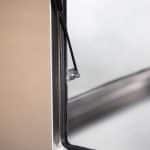 Close-up of a gas strut mechanism attached to the interior frame of an aluminium UTE canopy door