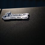 Close-up of black UTE canopy featuring engraved metal logo badge