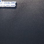 Close-up of the Chivalry metal logo badge on a UTE canopy surface