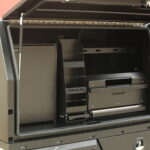 Black aluminium UTE canopy with multiple internal shelves and drawers